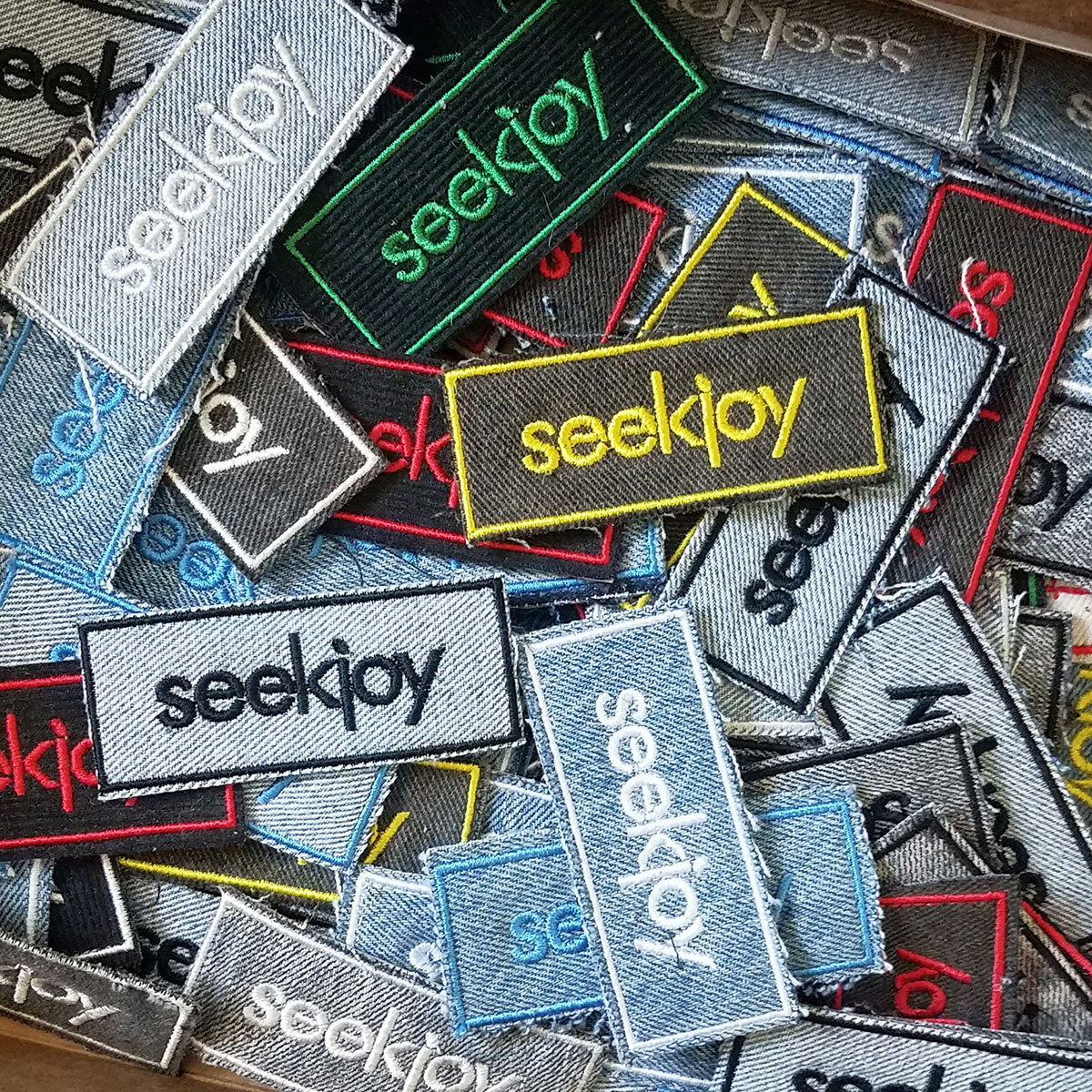 Pile of various SEEKJOY Patch Styles in a Box